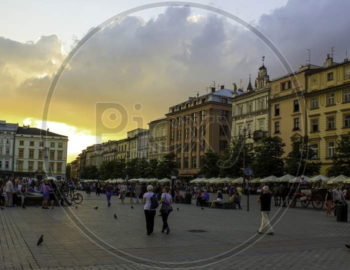 Krakow, Poland - May 23, 2014: A Street View Of Touristic Main Square At Sunset In The Center Of Krakow City In Poland