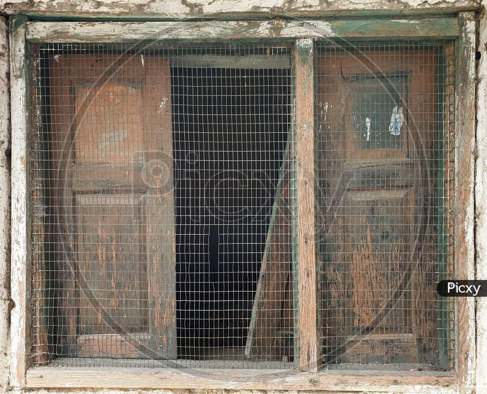 Photo of wooden window of old Indian house in hilly area of Himachal Pradesh, India