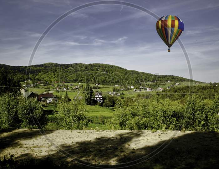 Wide Angle Shot Of Landscape With Air Balloon - Limanowa, Poland