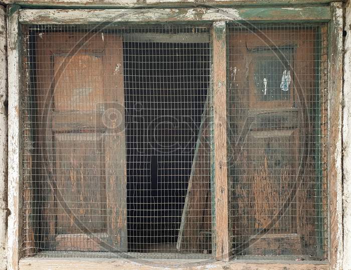 Photo of wooden window of old Indian house in hilly area of Himachal Pradesh, India