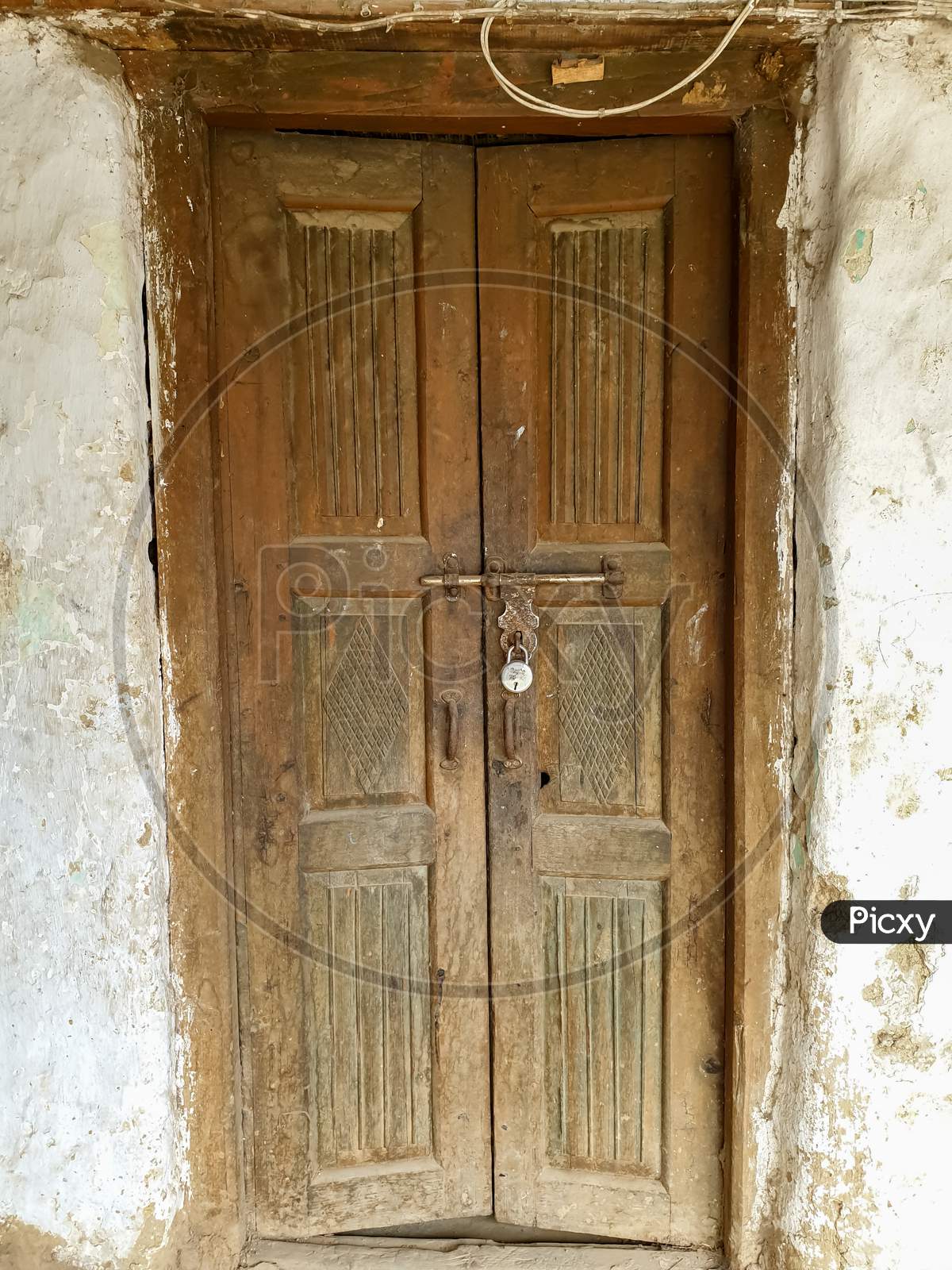 Photo of wooden door of old Indian house in hilly area of Himachal Pradesh, India