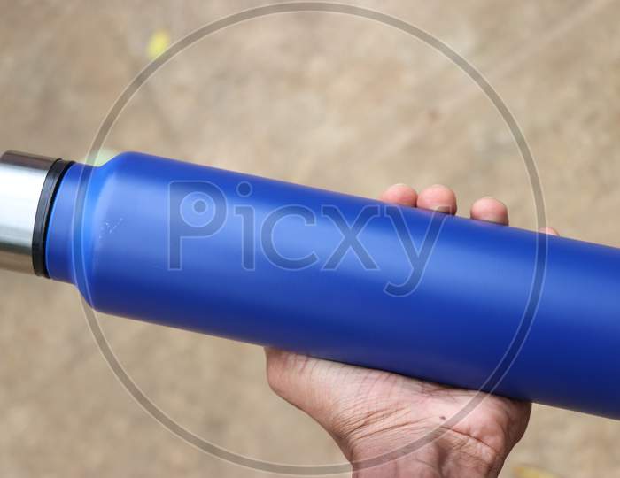 Water Flask Made Of Stainless Steel With Space For Text And Branding Held In Hand