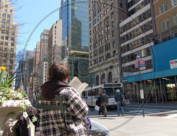 Man Reading A Book In Manhattan