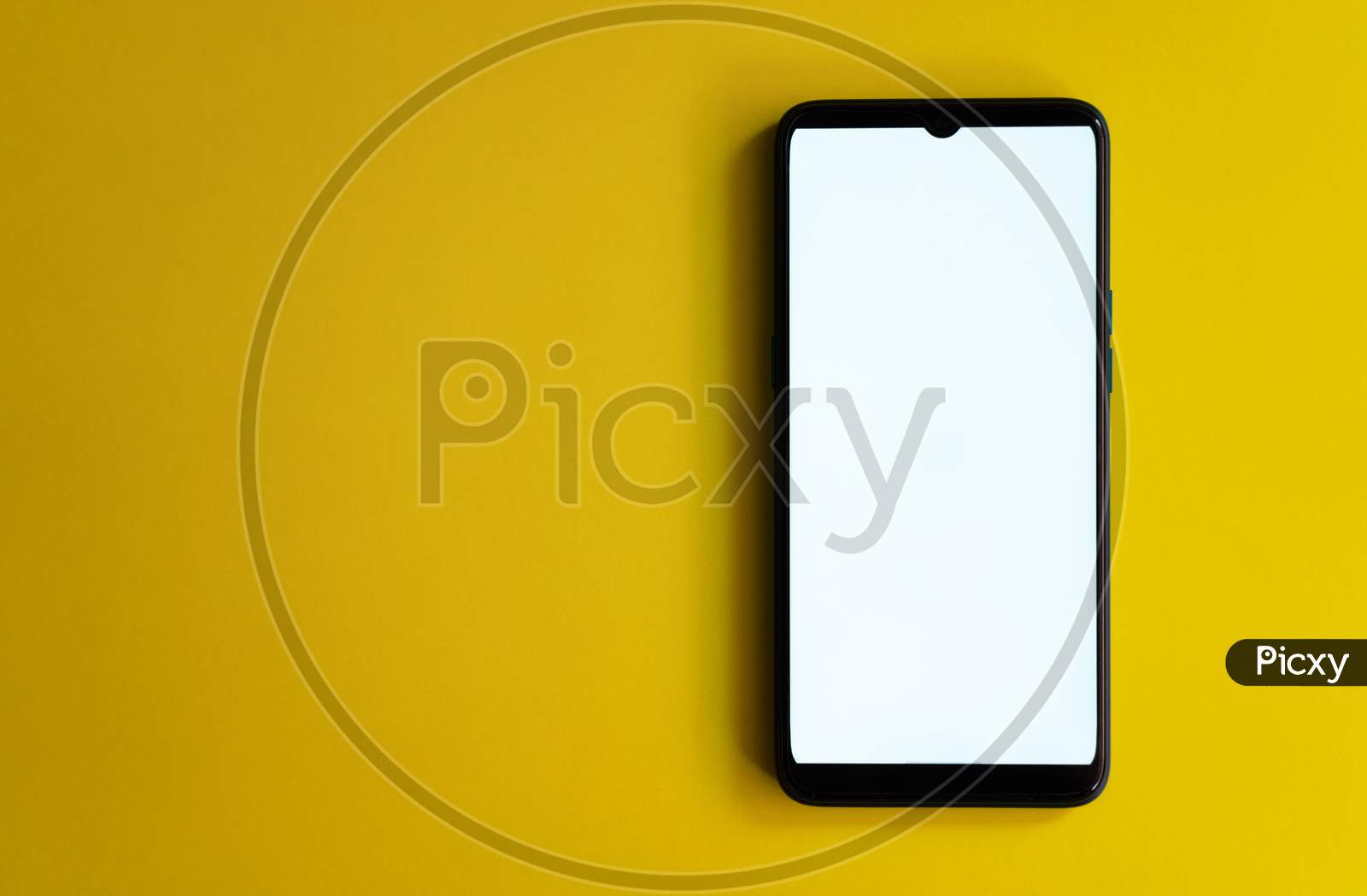 White screen on mobile phone on yellow background with space for text