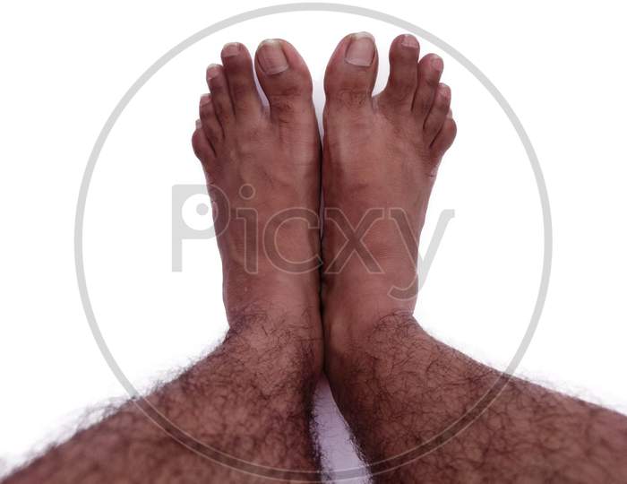 Legs with hairs Top view bare foot isolated on white background
