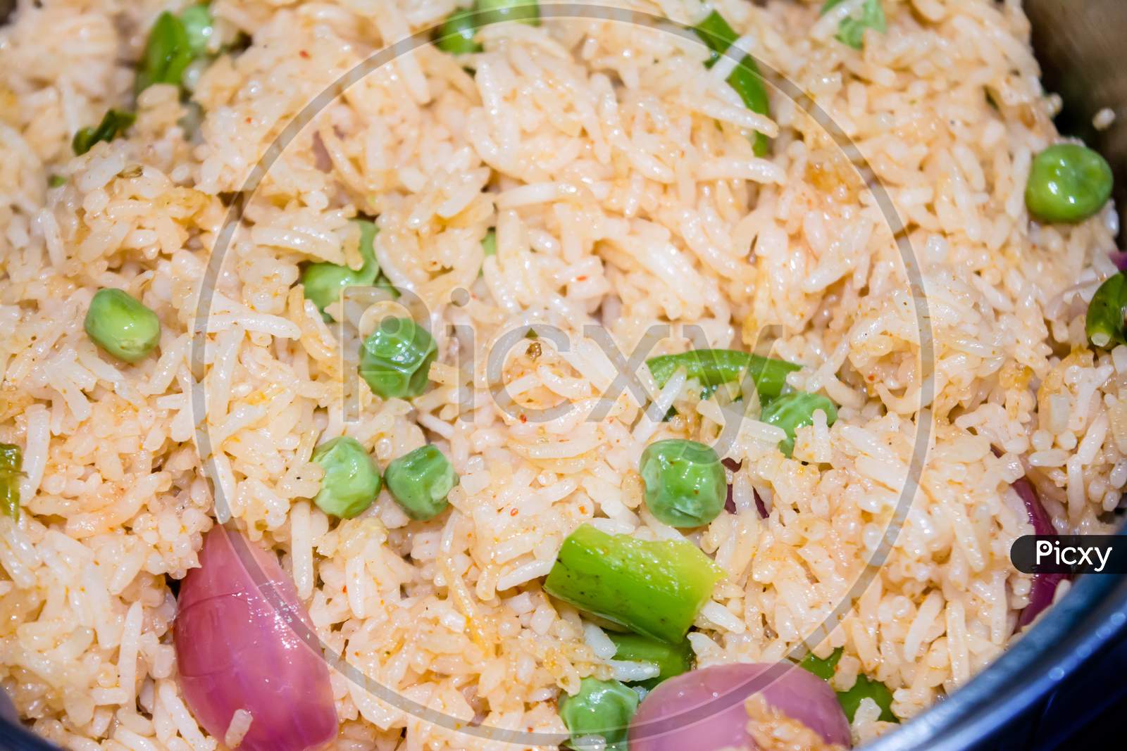 Homemade Chinese fried rice with vegetables, Veg Schezwan Fried Rice, peas, peppers, green beans, carrot. Selective Focus, Top view