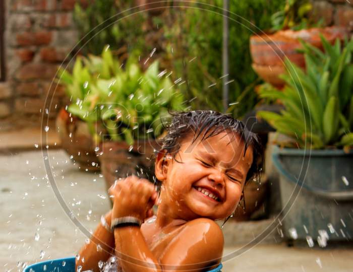 A baby playing with water