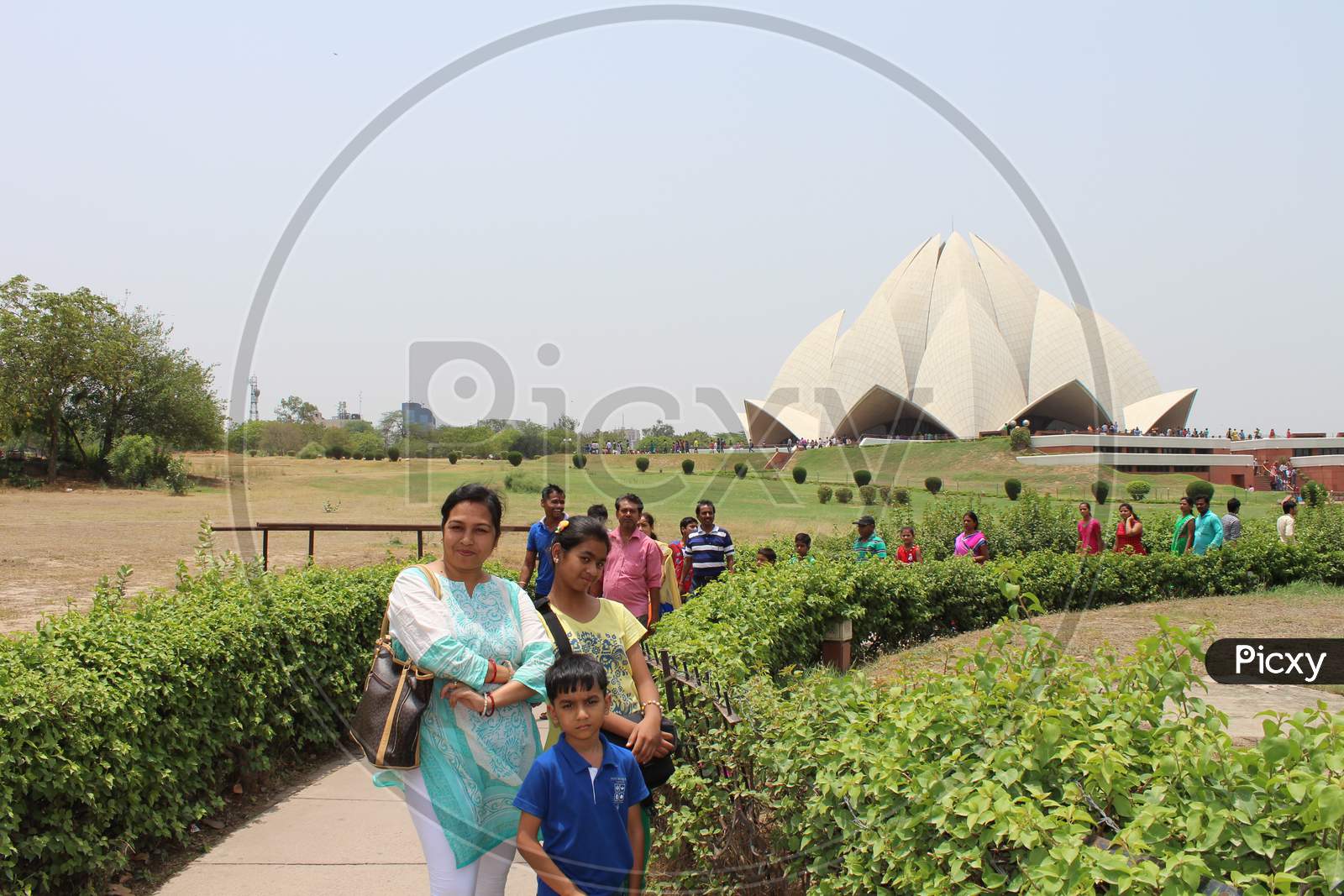 tourist posing by the entrance of Lotus Temple