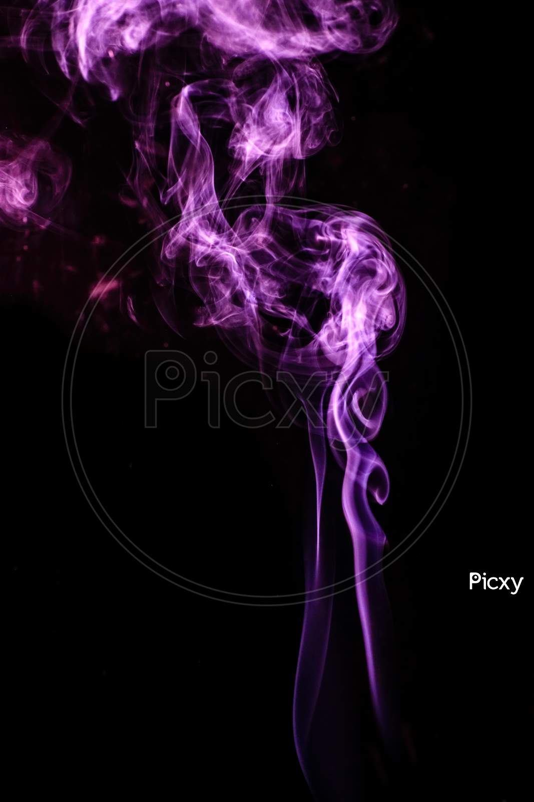 Purple Colored Puffed Smoke In A Dark Background