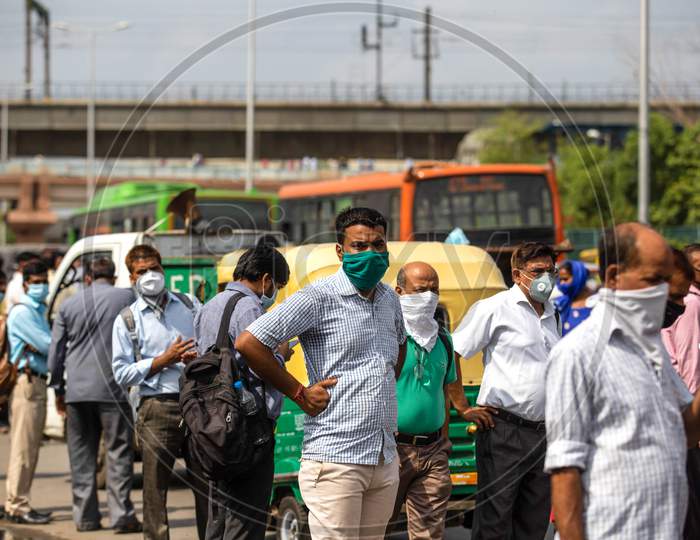 People flout social distancing norms as they wait to board a bus at Anand Vihar, in New Delhi, India On June 23, 2020.