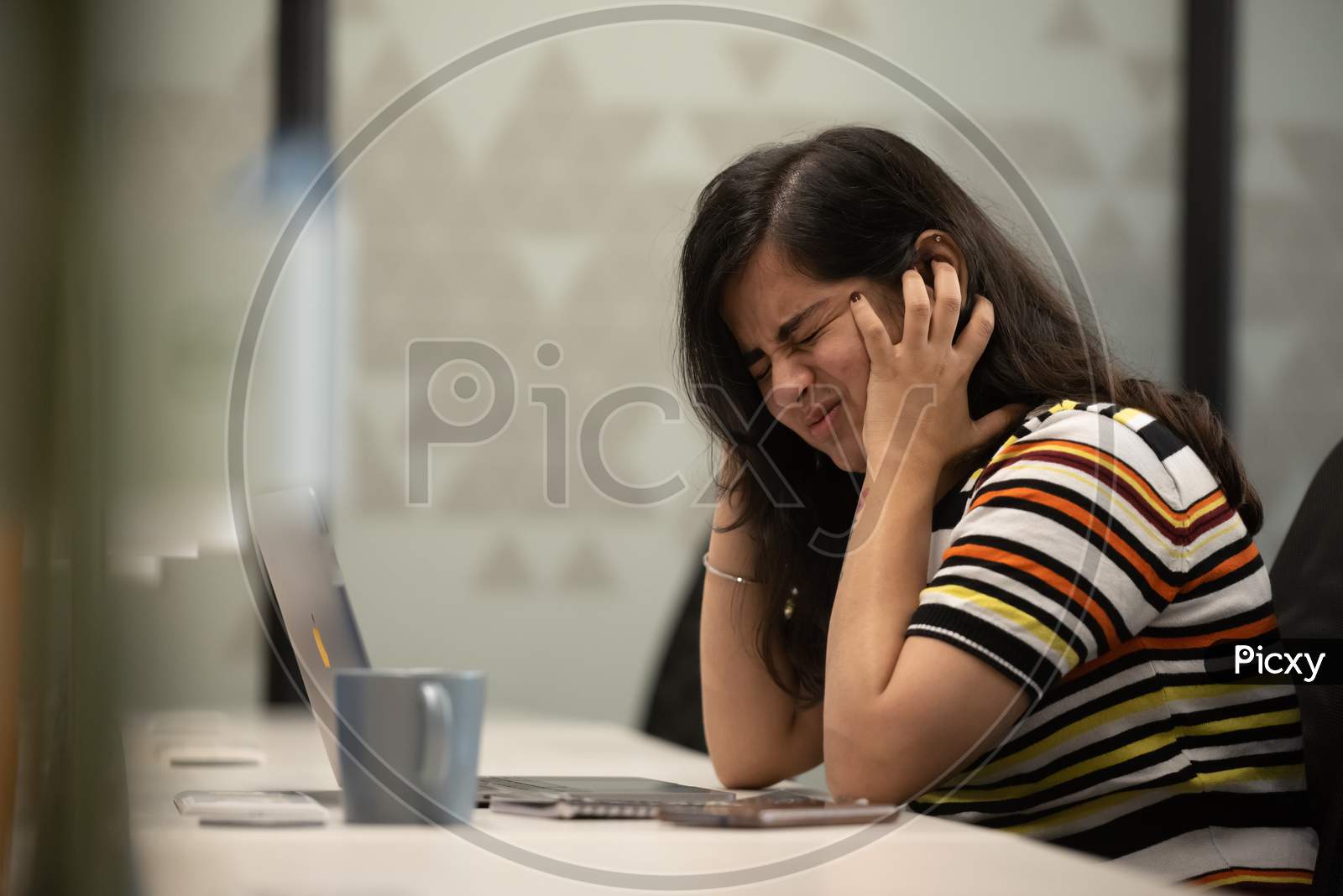 Depressed working woman crying at work