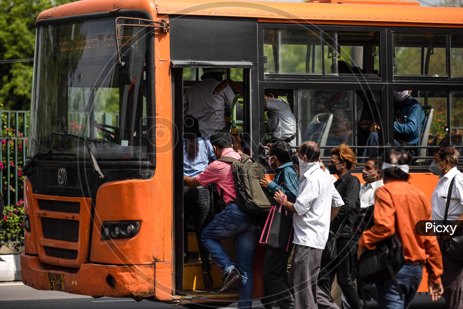 People flout social distancing norms as they board a bus at Anand Vihar, in New Delhi, India On June 23, 2020.