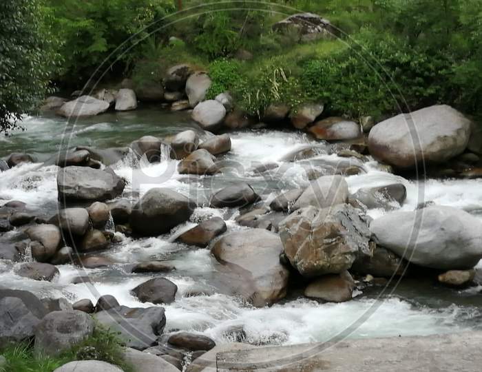 a stream gushing through the rocky terrain
