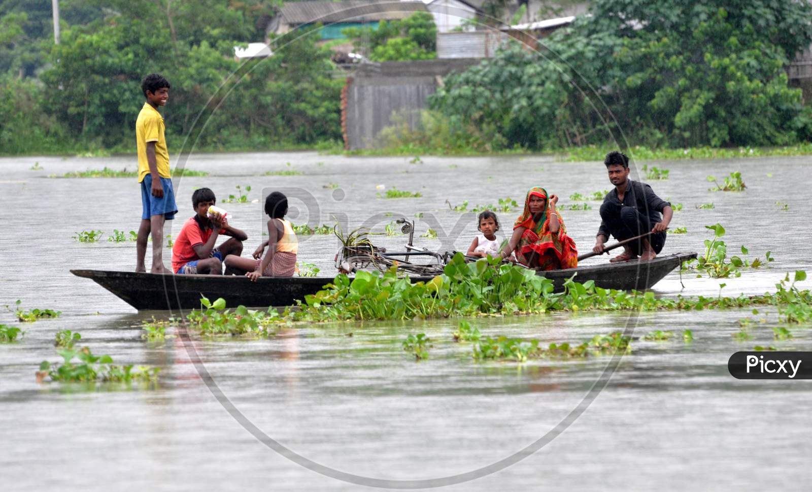 Flood Affected Villagers On Their Way To The Shelters In Morigaon District Of Assam On June 25,2020.