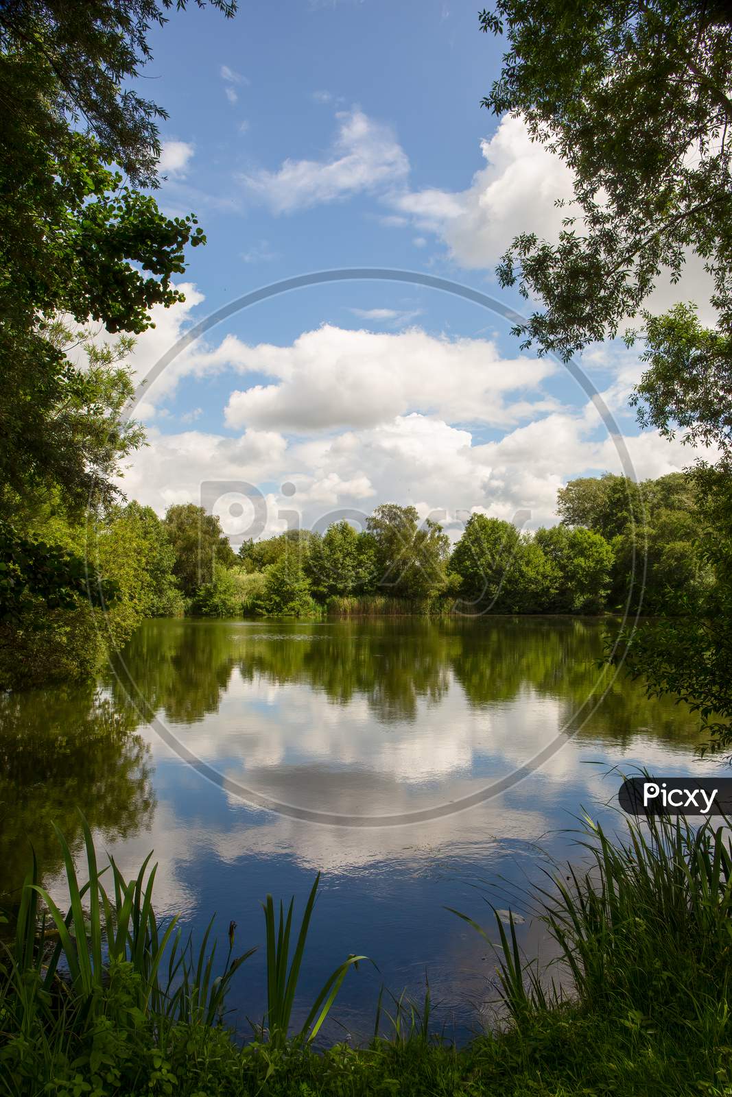 Lake Reflection Of Cloudy Blue Sky - Spring, Summers Season In England. Concept Of Peace In Nature