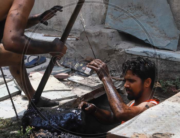 Manual Scavengers Cleans A Choked Drain, In New Delhi On March 23, 2020.