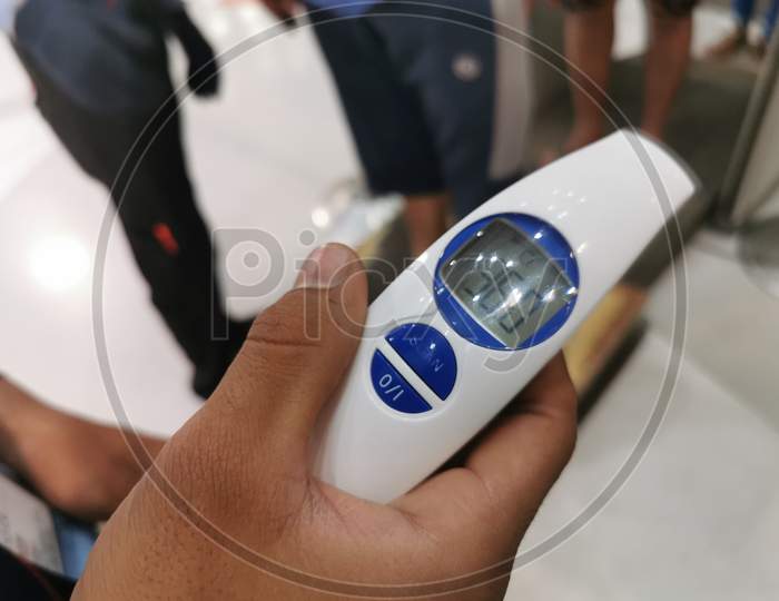 Temperature Check with Thermometer Machine at a Shopping Mall