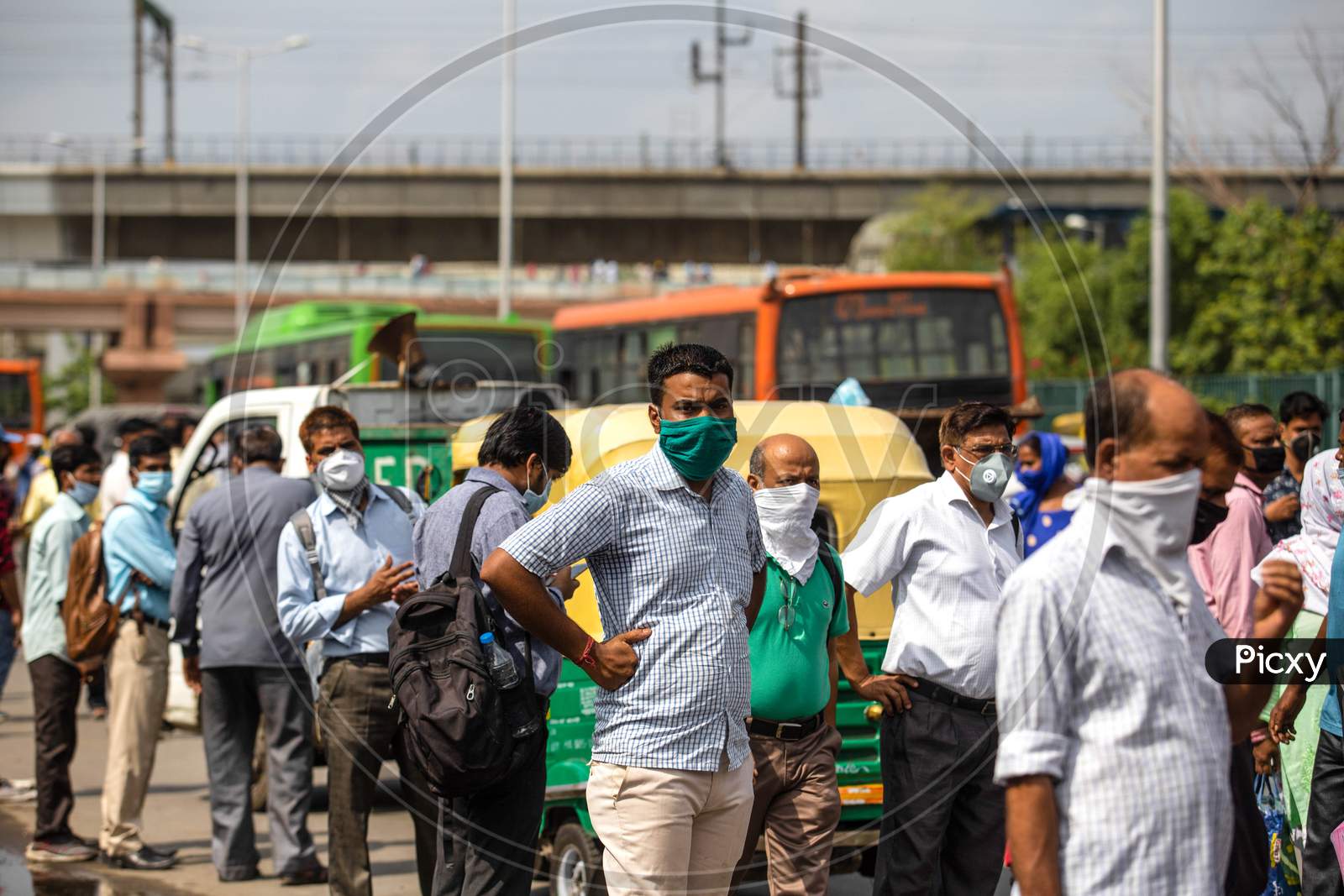 People flout social distancing norms as they wait to board a bus at Anand Vihar, in New Delhi, India On June 23, 2020.