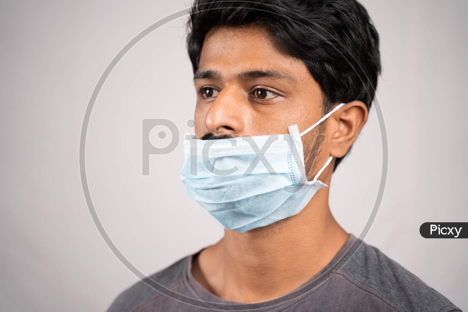 Young Man Wearing Medical Mask Below Nose - Concept Showing Of Improper Way Of Using Face Masks During Coronavirus Or Covid-19 Crisis.