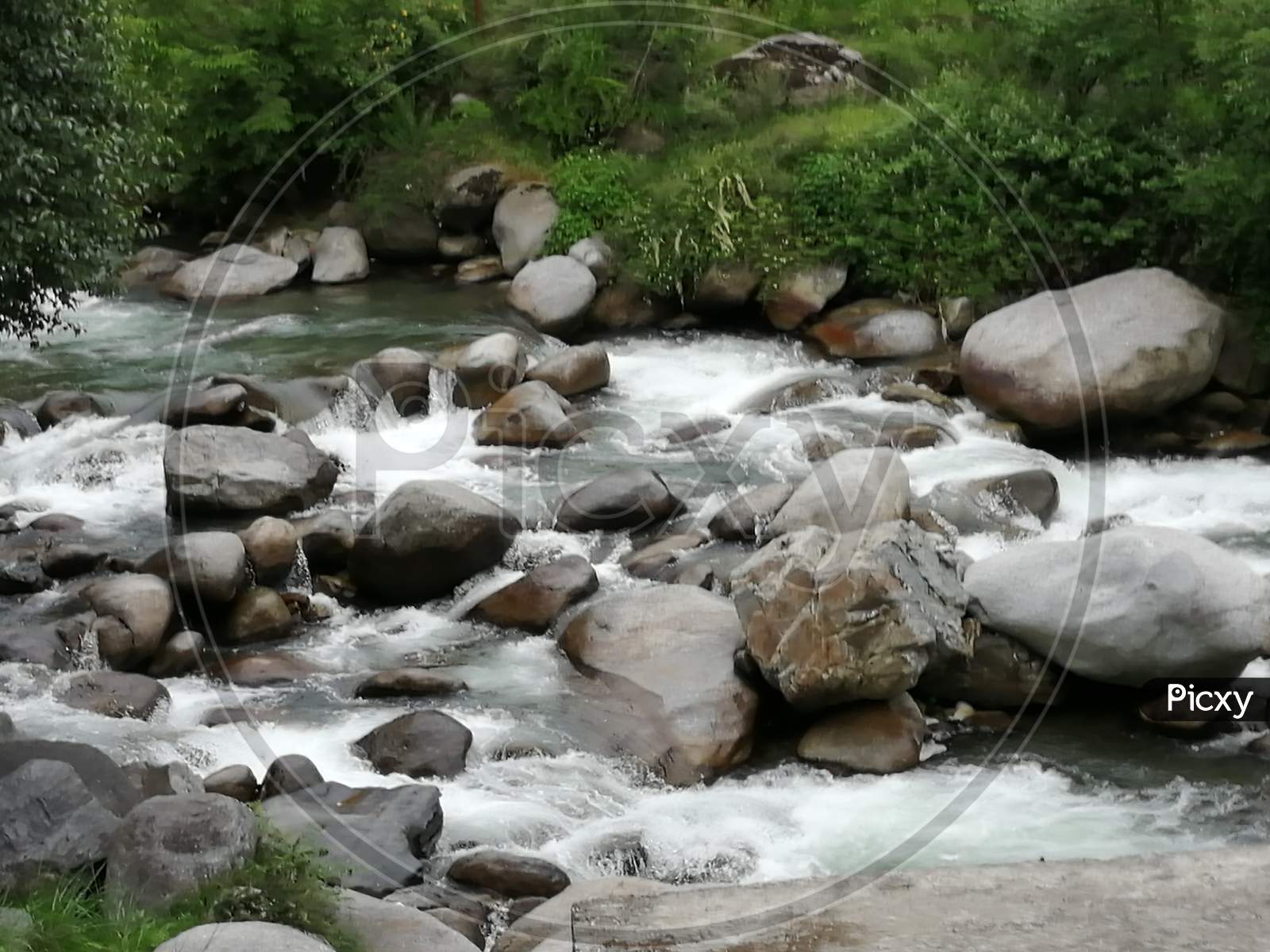 a stream gushing through the rocky terrain