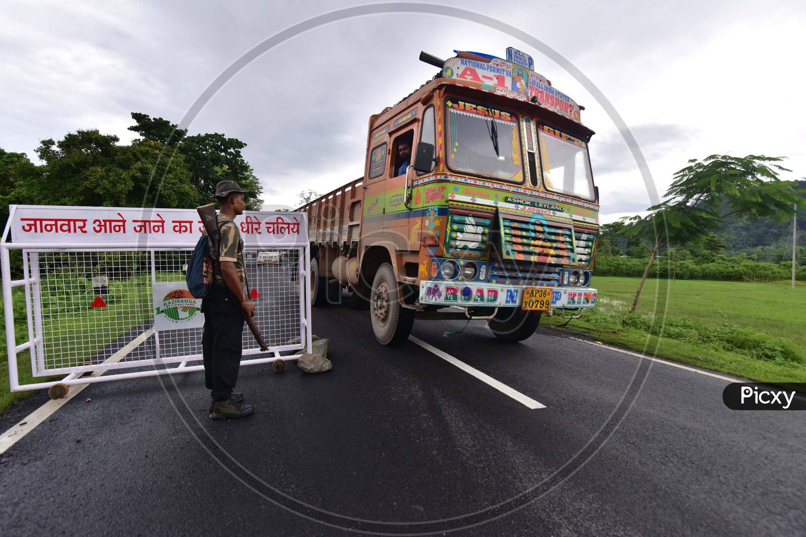 Forest Guard Patrol On A Road To Slowdown The Speed Of Vehicles As Wild Animals Cross A Highway To Move To Highlands Following Floods At The Kaziranga National Park In Assam on June 26,2020