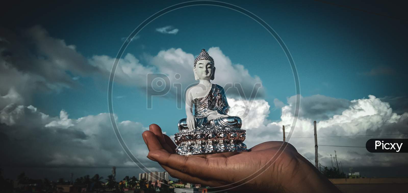 A beautiful statue of Lord Buddha on a palm of a person