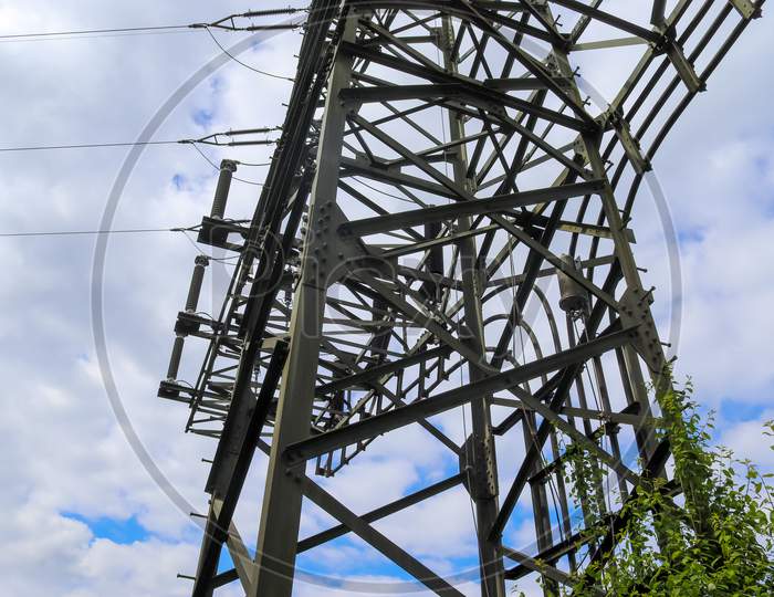 Close Up View On A Big Power Pylon Transporting Electricity In A Countryside Area In Europe
