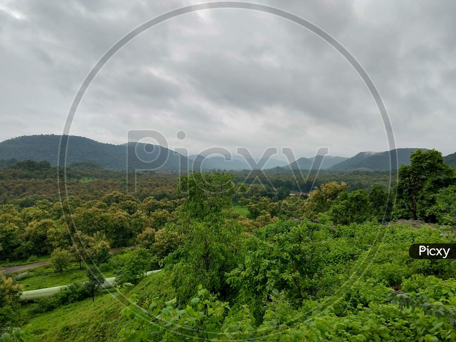 Tremendous Green Valley View With Foggy Mountains In The Background In Monsoon Season At Central India