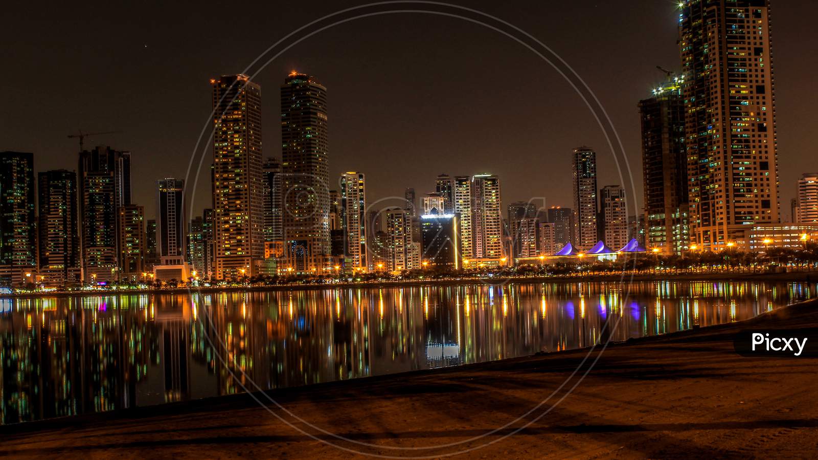A Reflection Shot Of A Cityscape At Al Majaz Beach Corniche, Sharjah, Uae.