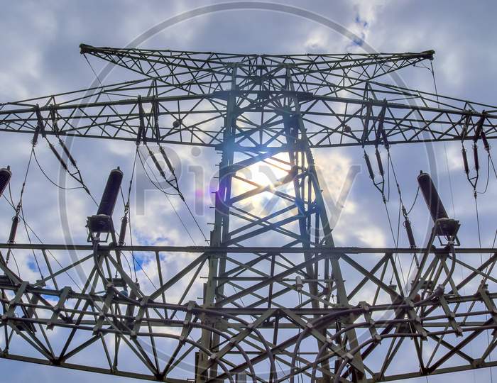 Close Up View On A Big Power Pylon Transporting Electricity In A Countryside Area In Europe