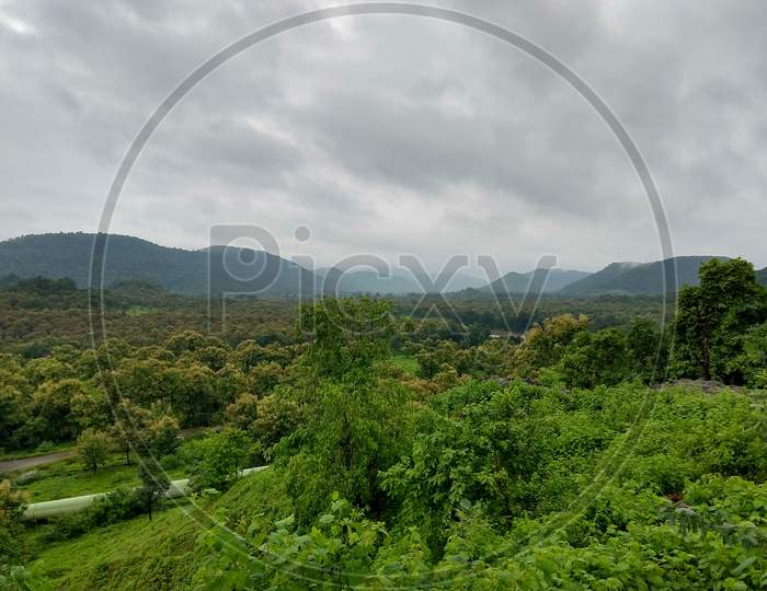 Tremendous Green Valley View With Foggy Mountains In The Background In Monsoon Season At Central India