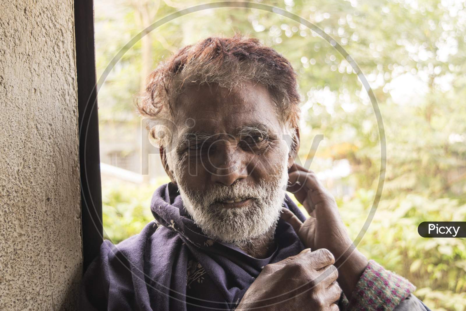 An Indian old man portrait during winter