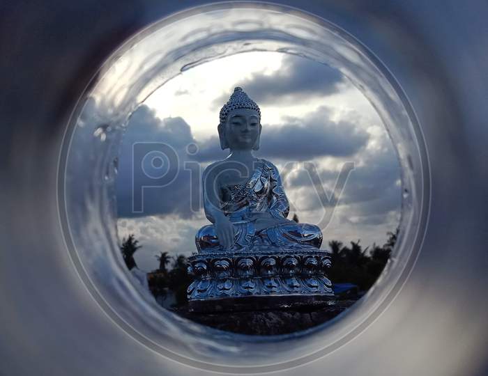 Picture of Lord Buddha clicked through a bottle.
