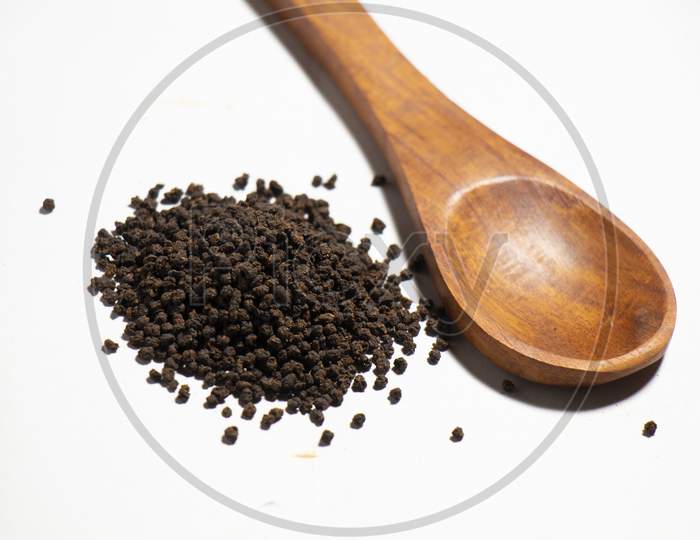 Dried Tea Leaves powder on Spoon With White Background