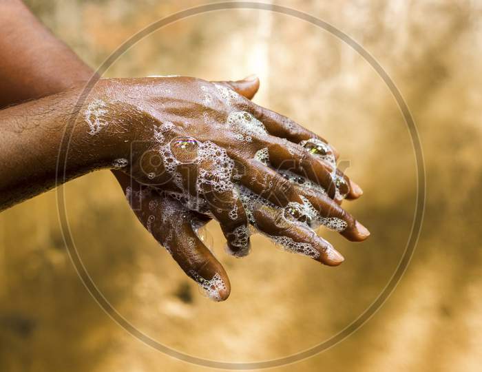 a man washing his hands by soap to maintain hygiene.stay healthy.avoid germ and virus.