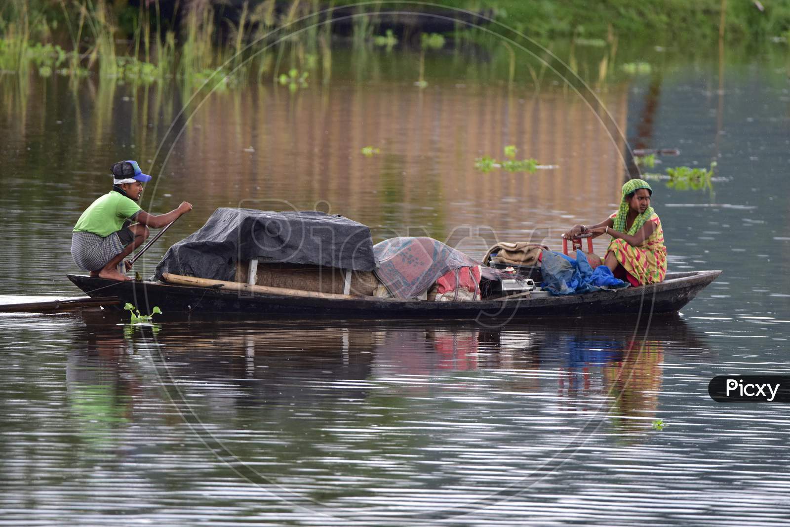 Flood Affected Villagers Are Transported On A Boat Towards A Safer Place At Bandardubi Village Near Kaziranga In Assam on June 26,2020