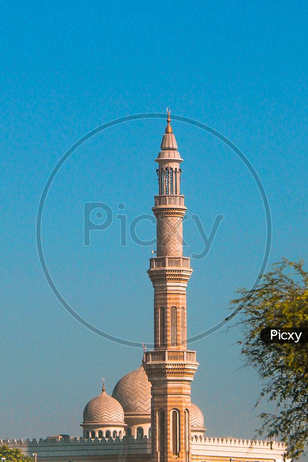 A Telephoto Of A Mosque Between Trees