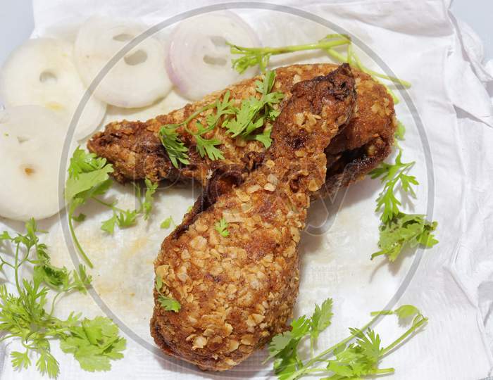 Hot and crispy fried chicken legs isolated on a white background