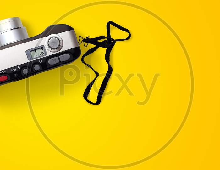 Old Slr Camera Placed On Yellow Surface Isolated With Copy Space