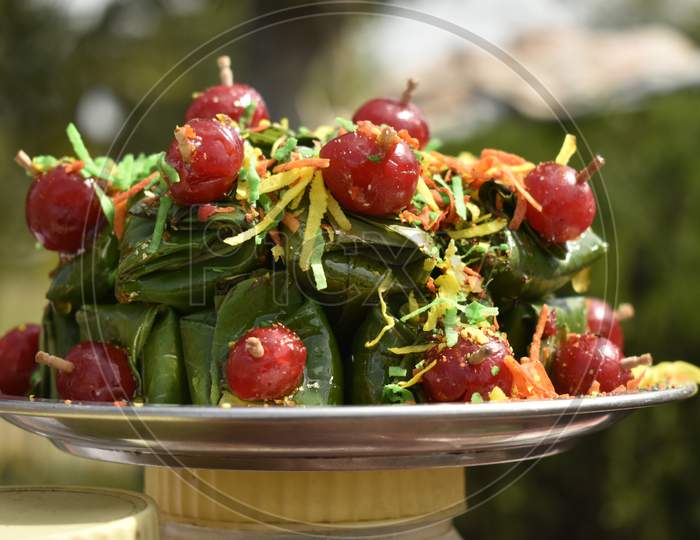 A Closeup Photograph Of Paan Or Betel Leaves Garnished With Jellies.