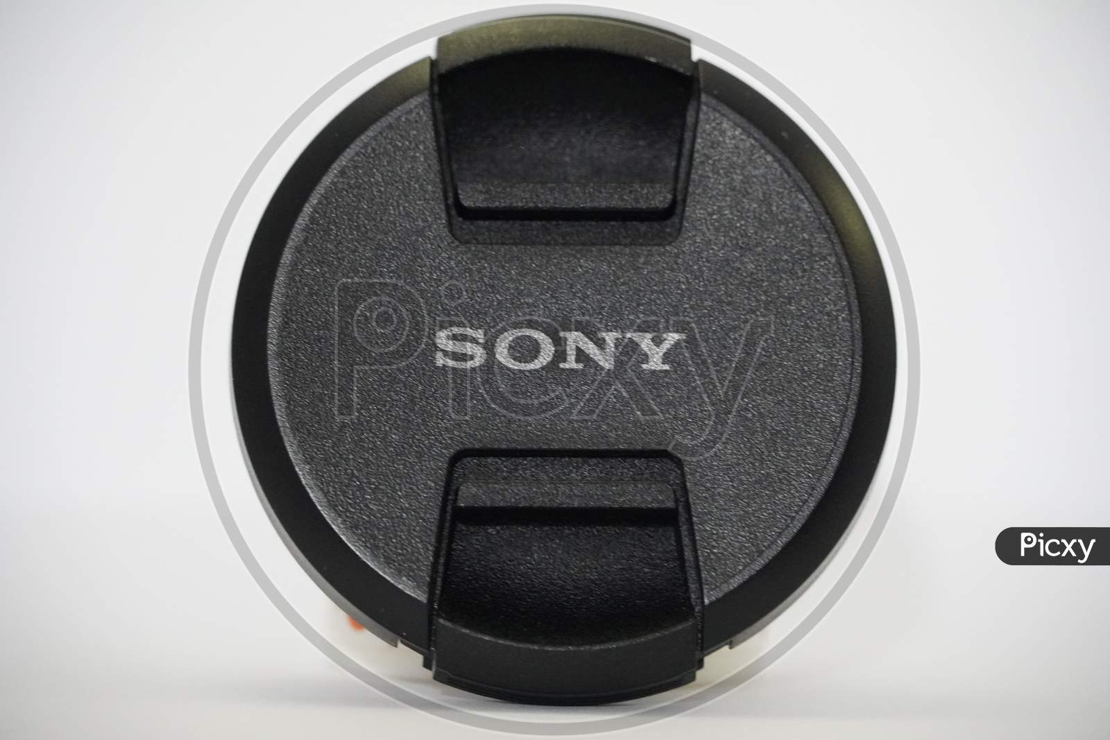 Sony Camera Lens Cap On White Background. Branded Cap Of Camera Lens Named Sony As Accessories For Those Whose Hobby In Photography. : Udaipur India - March 2020