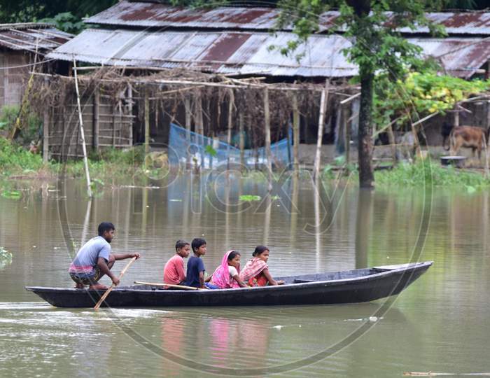 People Move On A Boat Over Floodwaters Following Heavy Rainfall At Bhurbandha Village In Nagaon District Of Assam On June 27,2020.