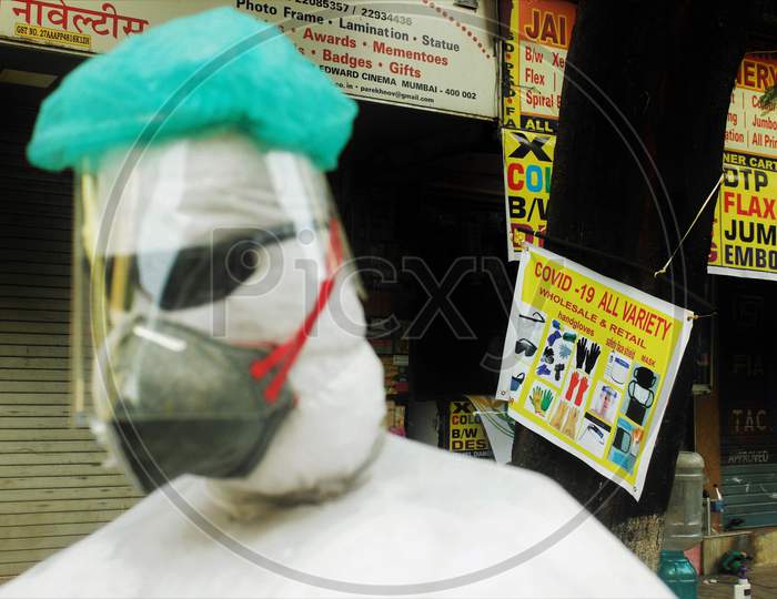 A shopkeeper displays a PPE kit makeshift mannequin by the roadside, in Mumbai, India on June 20, 2020.