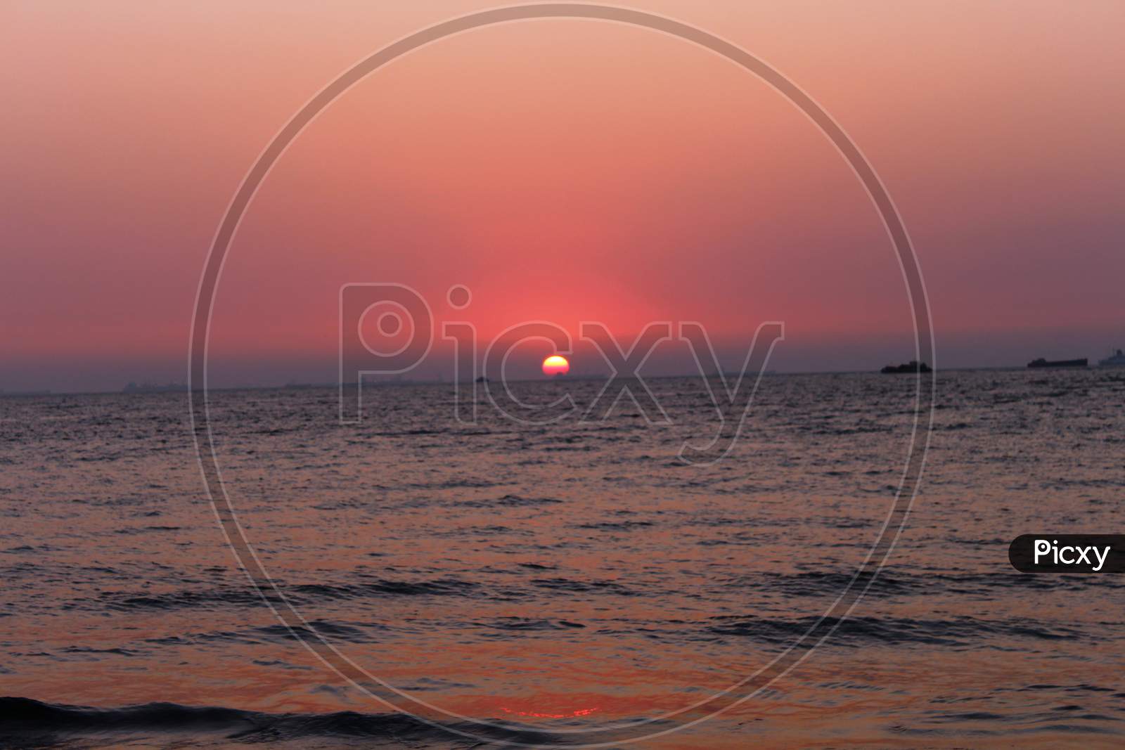 view of the pinkish sky during sunset at Miramar beach, Goa