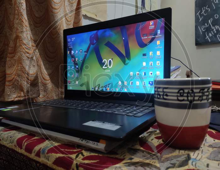 Laptop and cup of coffee in midnight