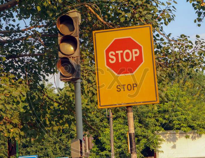 "New Delhi /India -21.06.2020:Stop Sign  Boards Near  Traffic Lights  and Tree"
