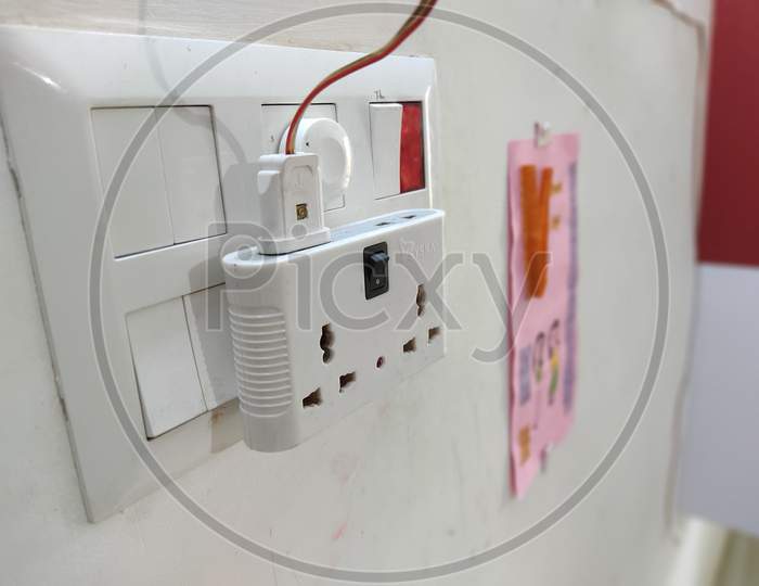 multiplug inserted in home plug socket