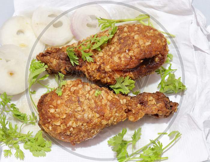 Hot and crispy fried chicken legs isolated on a white background