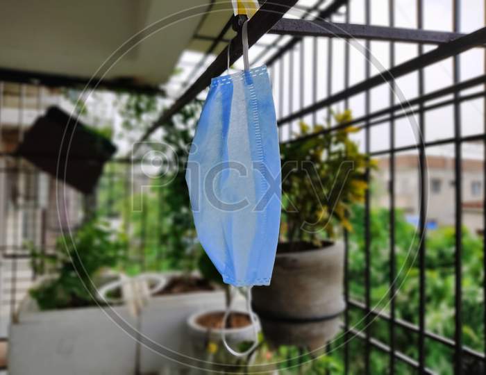 Face Mask disposable kept hanging blue in colour
