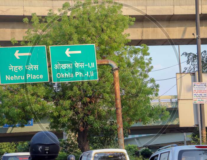 "New Delhi/India-21.06.2020: traffic sign Boards Direction from Nehru place and ohkla Ph I,II  near Tree Car , and Traffic Light "